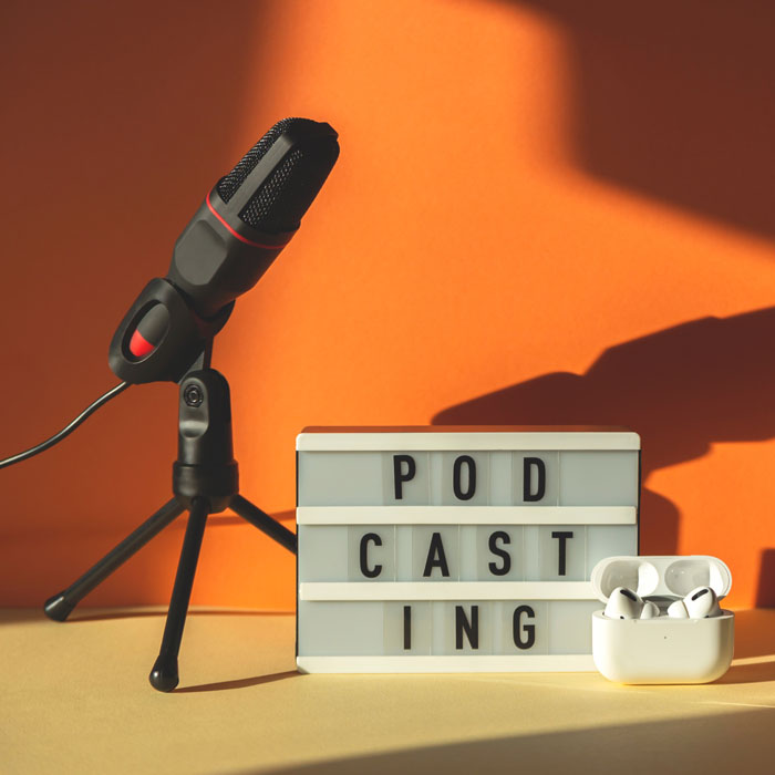 podcasting lettering next to microphone and wirele NLE8V2S 2